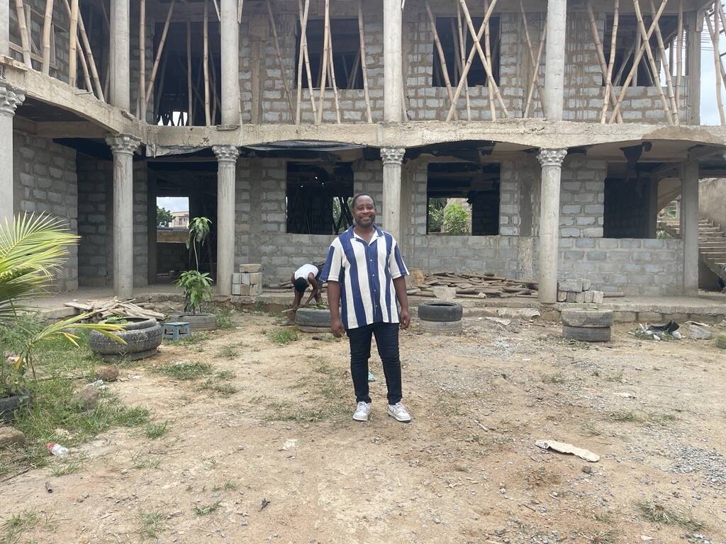 Emmanuel at the school’s new campus under construction. Photo Credit: Priscilla Armah/Opportunity International